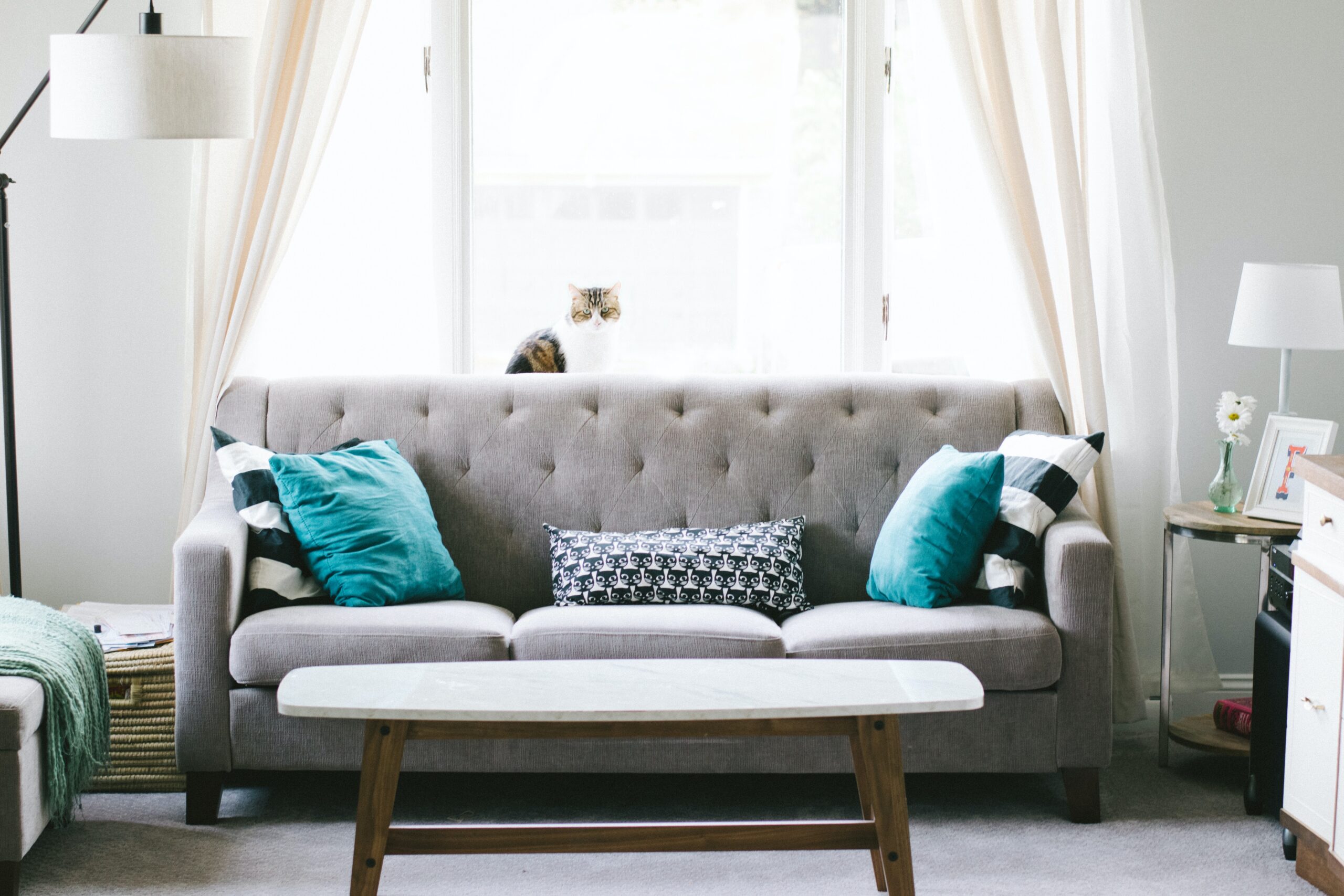 A nice clean living room with sofa and table.